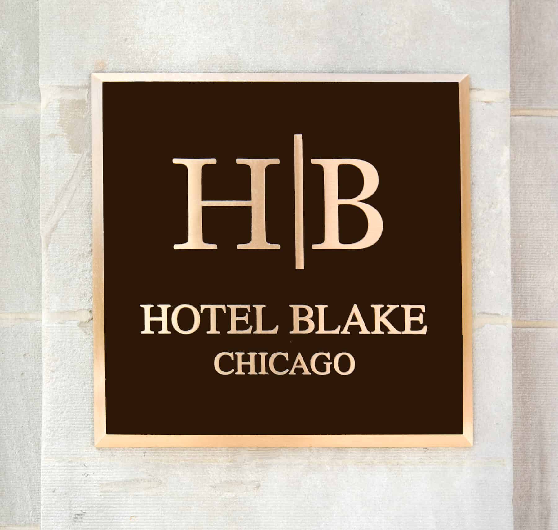 Custom Metal Sign and Stonework for Black Hotel Exterior Remodel by Commercial Builder & General Contractor Structural Enterprises