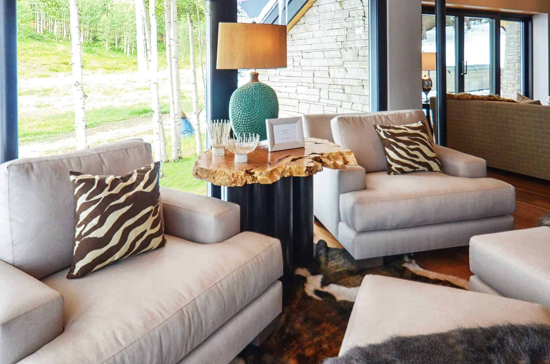 A Cozy Sitting Area with Oversized Chairs and Live Edge Side Table in Aspen, Colorado Custom Home. Luxury Home Building Interiors