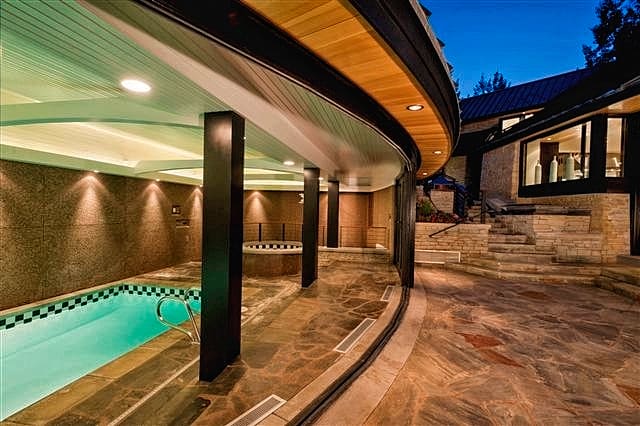 Indoor Outdoor Swimming Pool with Collapsible Glass Doors in Aspen, Colorado Custom Home. Luxury Home Building Interiors