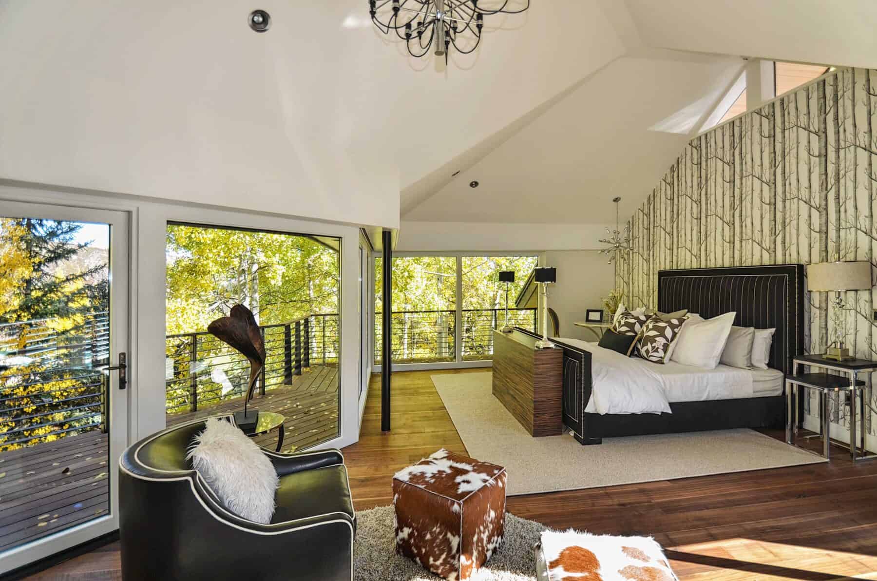 Master Bedroom with Black and White Pinstriped Bed in Aspen, Colorado Custom Home. Luxury Home Building Interiors