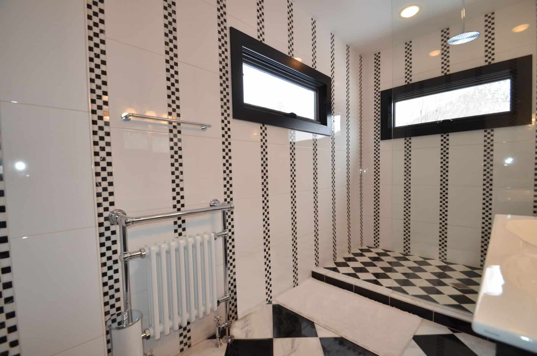 Black and White Modern Checkered Board Pattern Tiled Kids Bathroom with Glass Wall in Aspen, Colorado Custom Home. Luxury Home Building Interiors