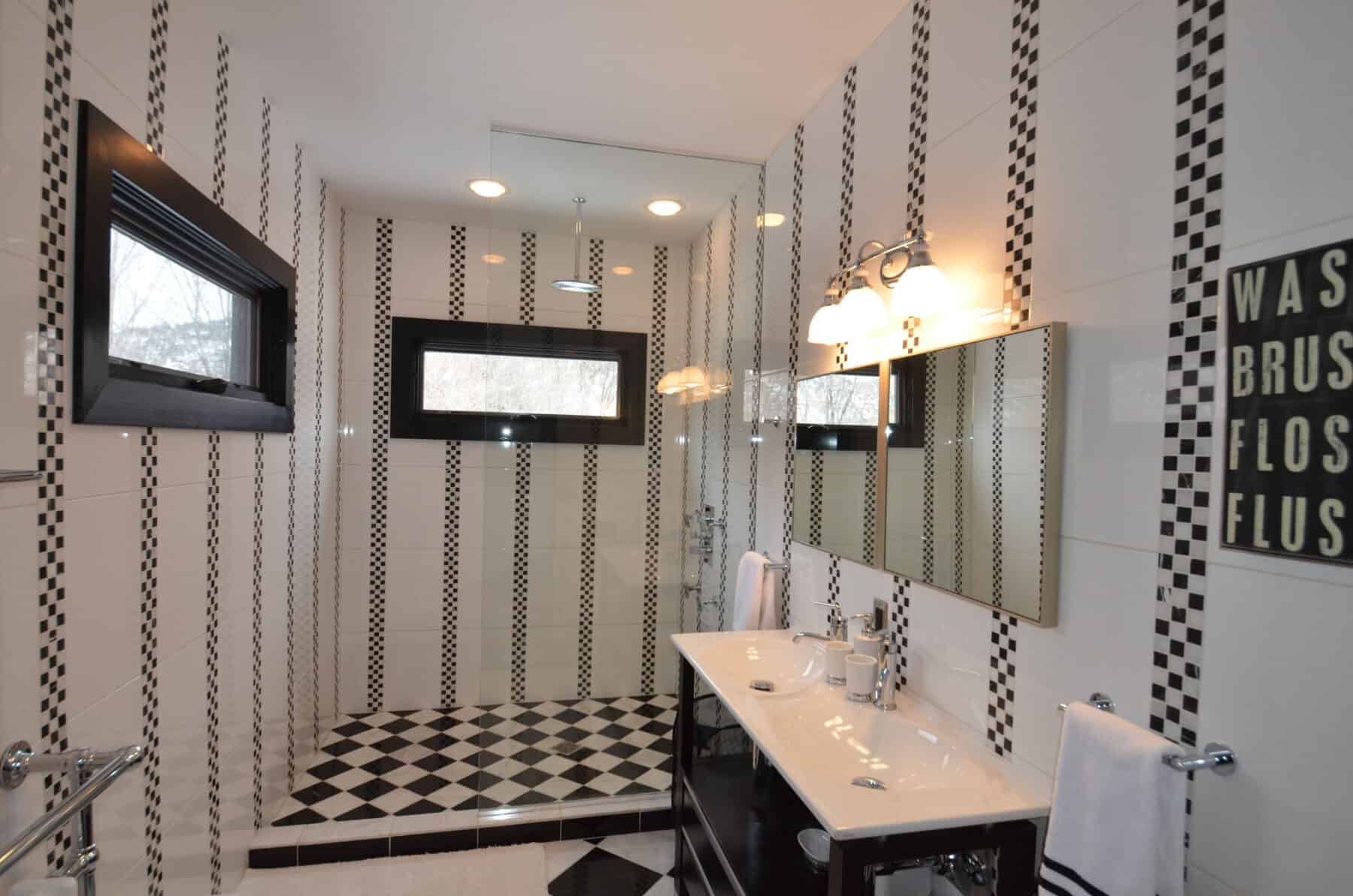 A Whimsical Checkerboard Harlequin Tiled Bathroom with a Modern Twist and Rain Shower in Aspen, Colorado Custom Home. Luxury Home Building Interiors