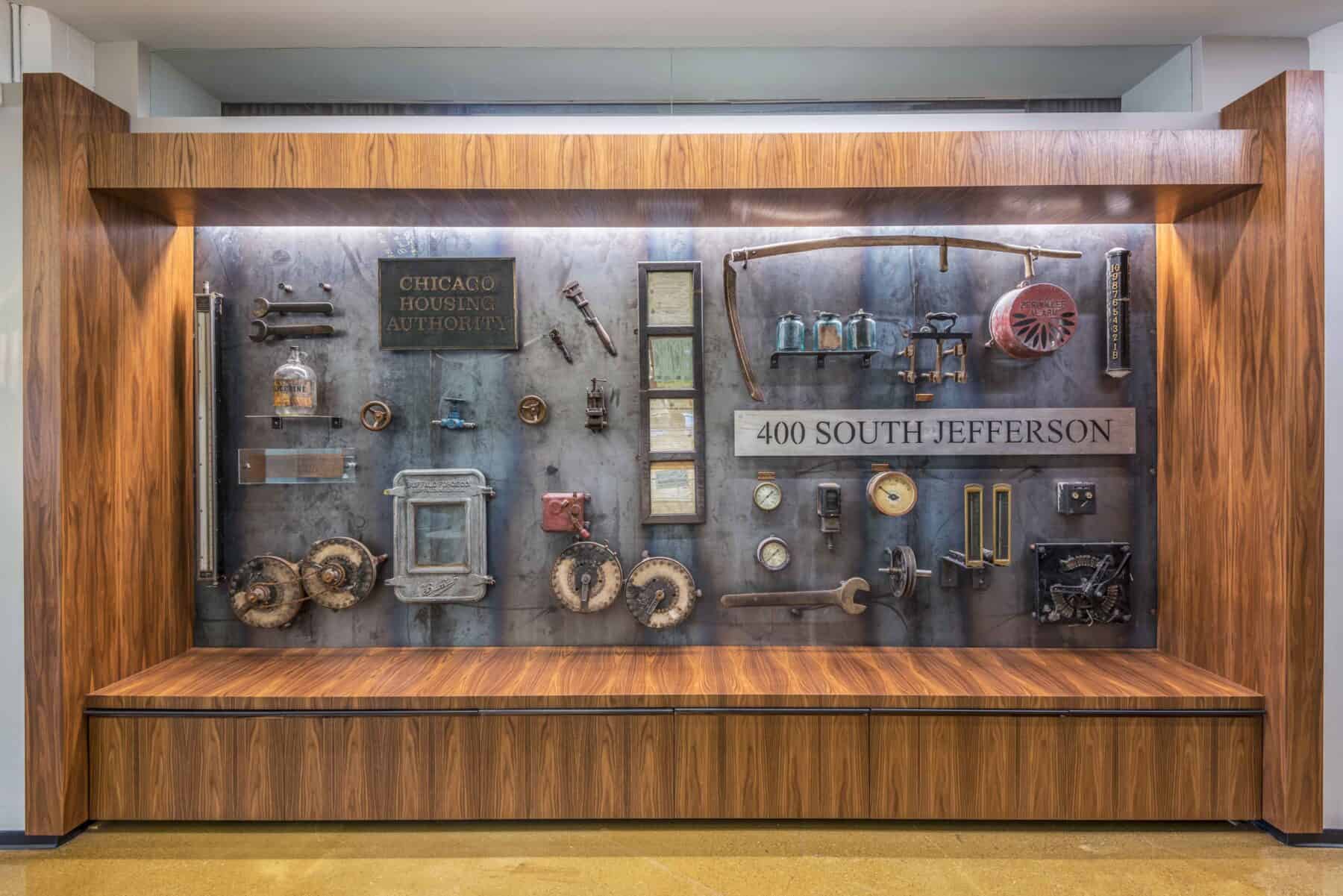 Custom Featured Wall of Artifacts Encased in Reclaimed Wood from Construction Specialty Projects by Commercial Builder & General Contractor Structural Enterprises