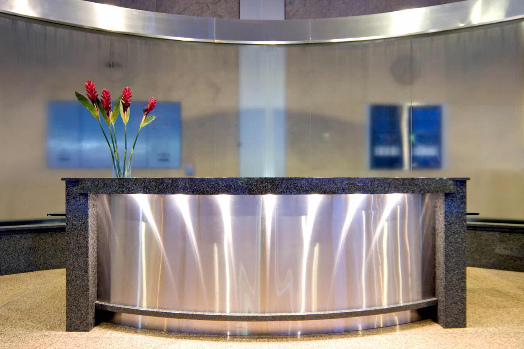 Stone and Metal Curved Reception Desk for Jackson Street Lobby by Commercial Builder & General Contractor Structural Enterprises