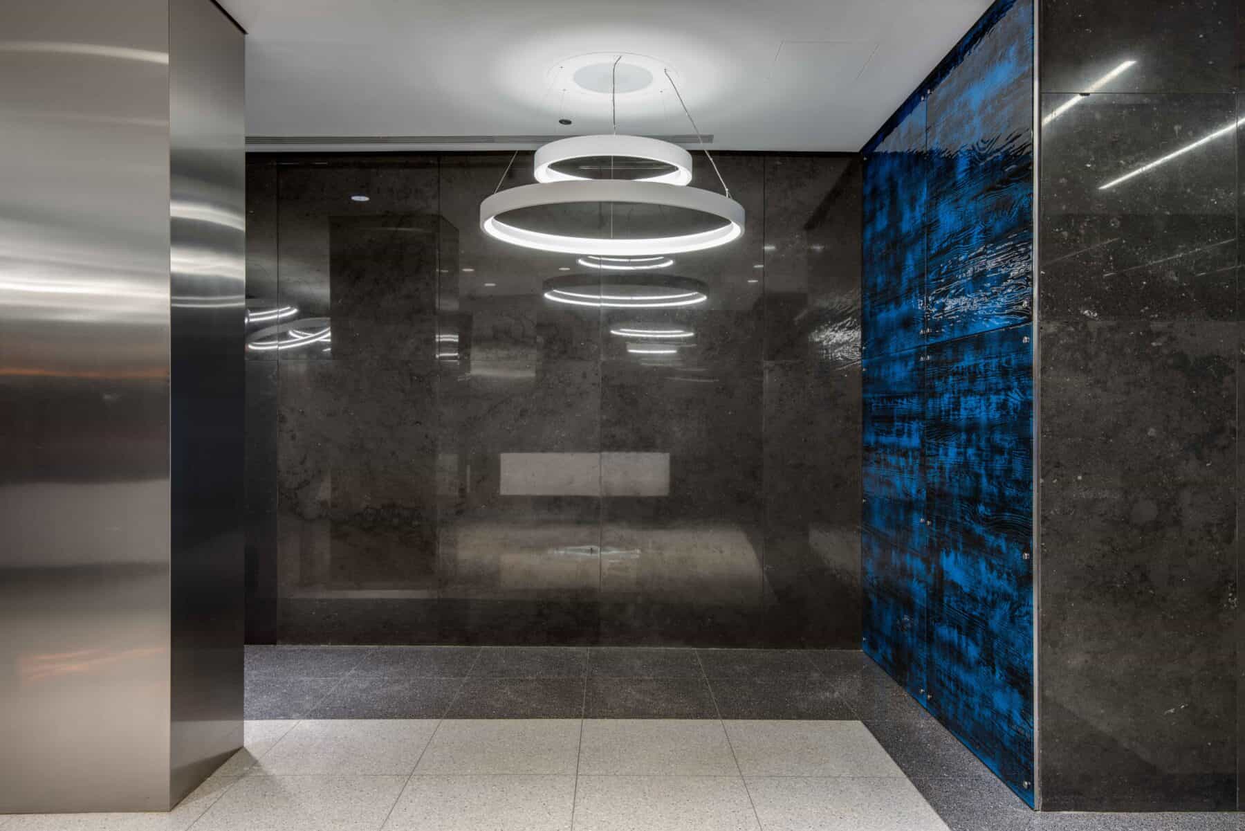 Michigan Avenue Lobby Remodel with Custom Circular lights and Glass Wall Panels by Commercial Builder & General Contractor Structural Enterprises