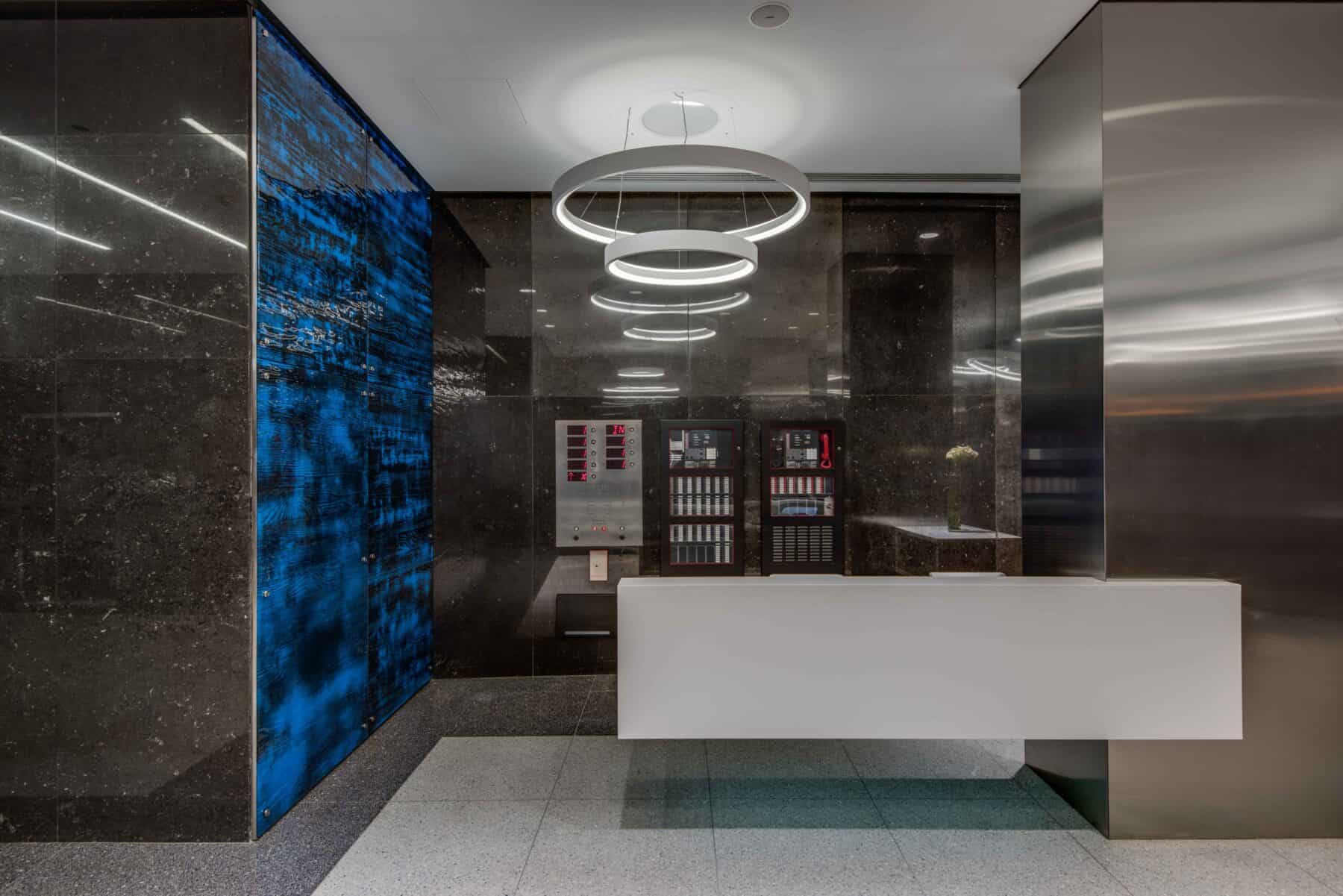 Modern Custom Glass Wall Panels and White Floating Reception Desk at Michigan Avenue Lobby by Commercial Builder & General Contractor Structural Enterprises