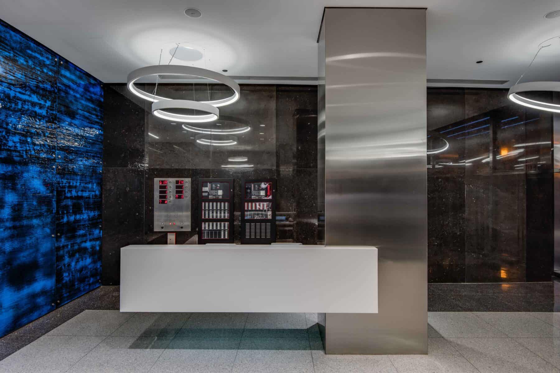 Modern Custom Circular LED Lights and White Floating Reception Desk at Michigan Avenue Lobby by Commercial Builder & General Contractor Structural Enterprises