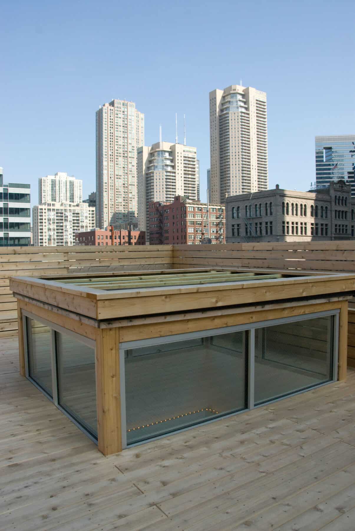 Custom Rooftop Deck with Wood Fence and Skylight from Construction Specialty Projects by Commercial Builder & General Contractor Structural Enterprises