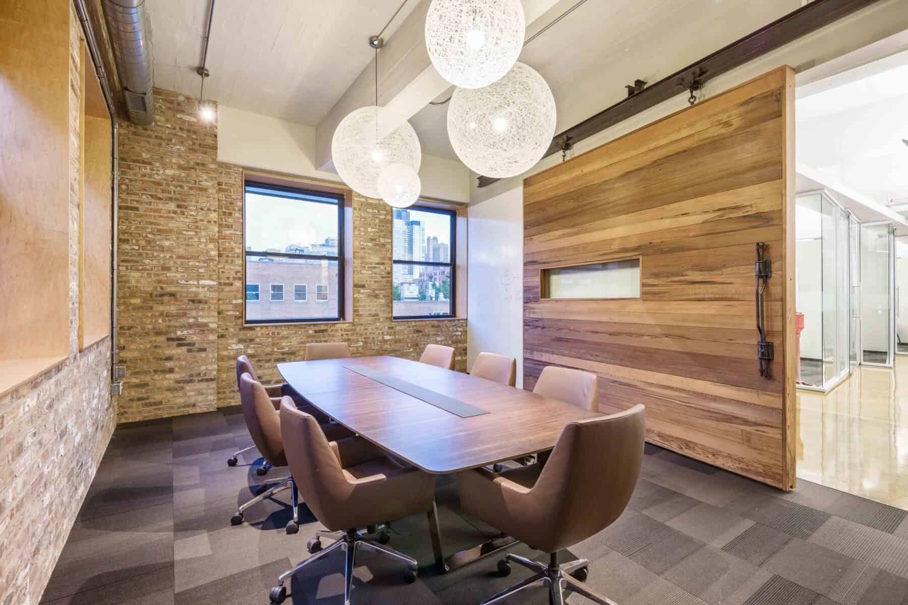 Office Meeting Room with Over Sized Barn Door with Window made of Reclaimed Wood by Commercial Builder & General Contractor Structural Enterprises