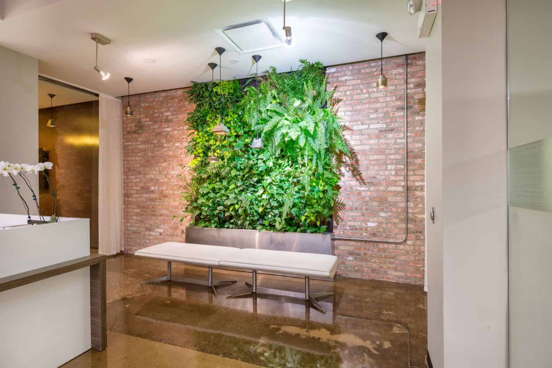 Office Remodel with Exposed Brick and Plant Wall by Commercial Builder & General Contractor Structural Enterprises
