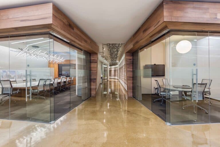 Spectacular Office Remodel with Floor to Ceiling Glass Wall and Doors with Custom Wood Work and Metal Art by Commercial Builder & General Contractor Structural Enterprises