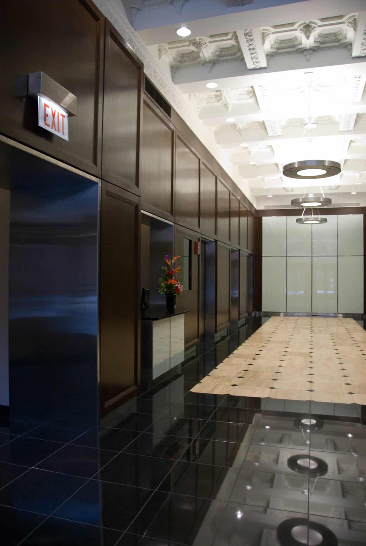 Custom Glass Wall Panels with Hidden Door and Wood Panels for Adams Street Lobby Remodel by Commercial Builder & General Contractor Structural Enterprises