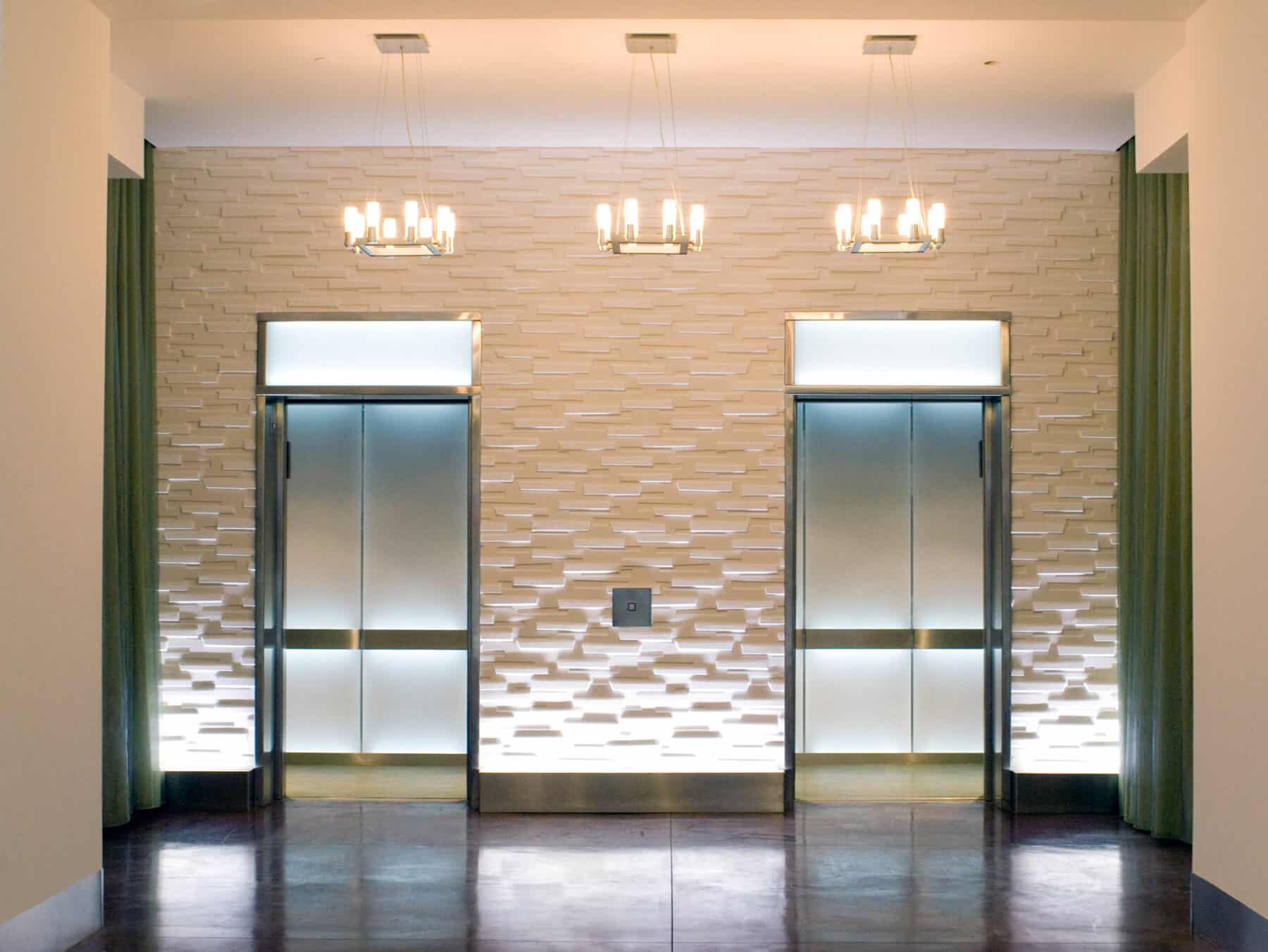 Elevator Interior with Back lit Glass for West Jackson Lobby Remodel by Commercial Builder & General Contractor Structural Enterprises