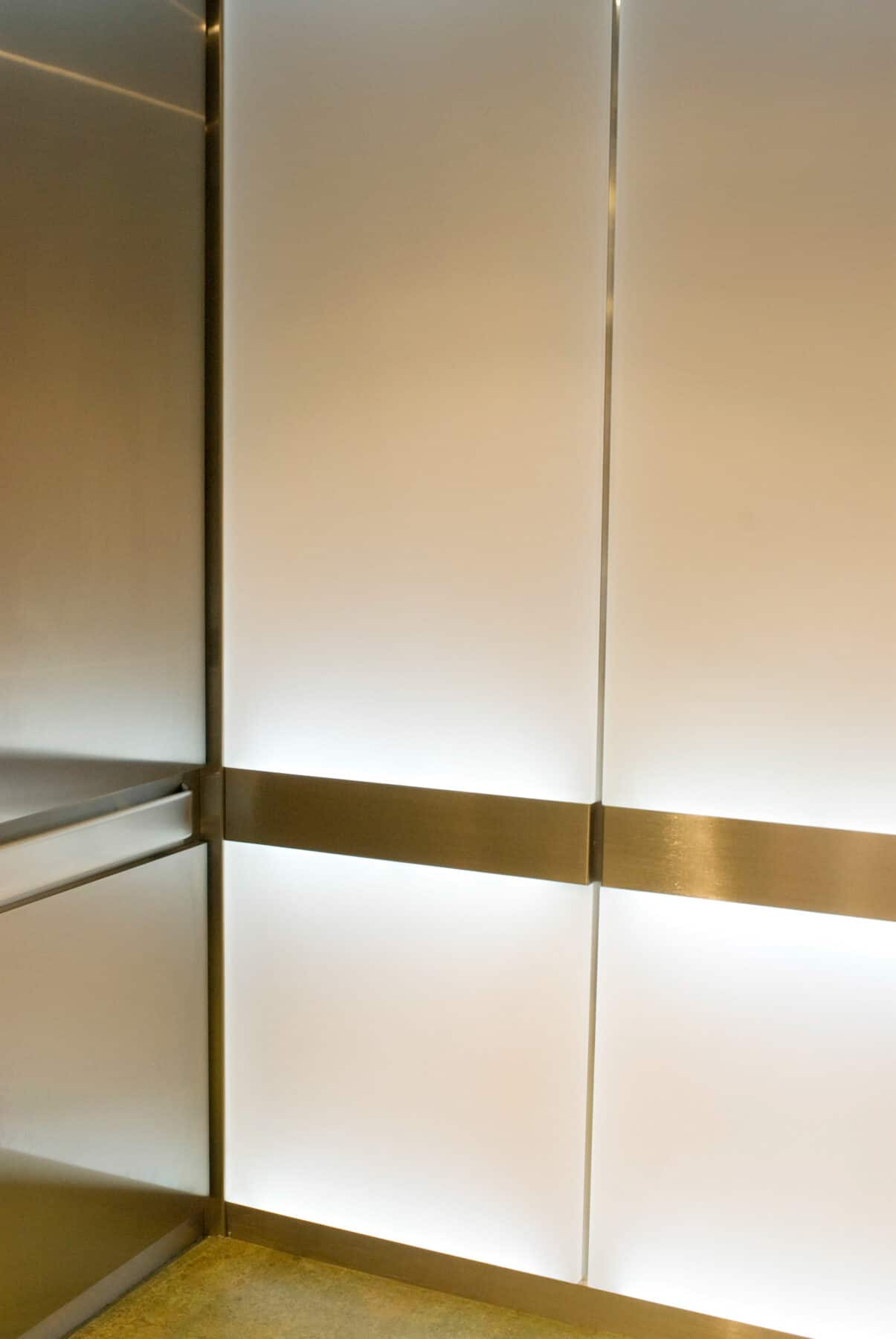 Custom Elevators with Back lit Glass and Polished Metal Handrails for West Jackson Lobby Remodel by Commercial Builder & General Contractor Structural Enterprises